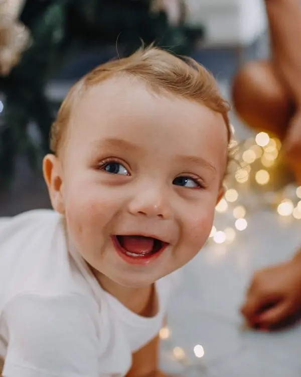 A baby boy laughing with delight